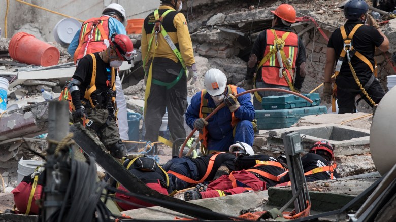 Rescuers work on the cleanup of a collapsed building in search of survivors in Mexico City on September 22, 2017. Hopes of finding more survivors after Mexico City's devastating quake dwindled to virtually nothing on Sunday, five days after the 7.1 tremor rocked the heart of the mega-city, toppling dozens of buildings and killing more than 300 people. / AFP PHOTO / Guillermo Arias (Photo credit should read GUILLERMO ARIAS/AFP/Getty Images)