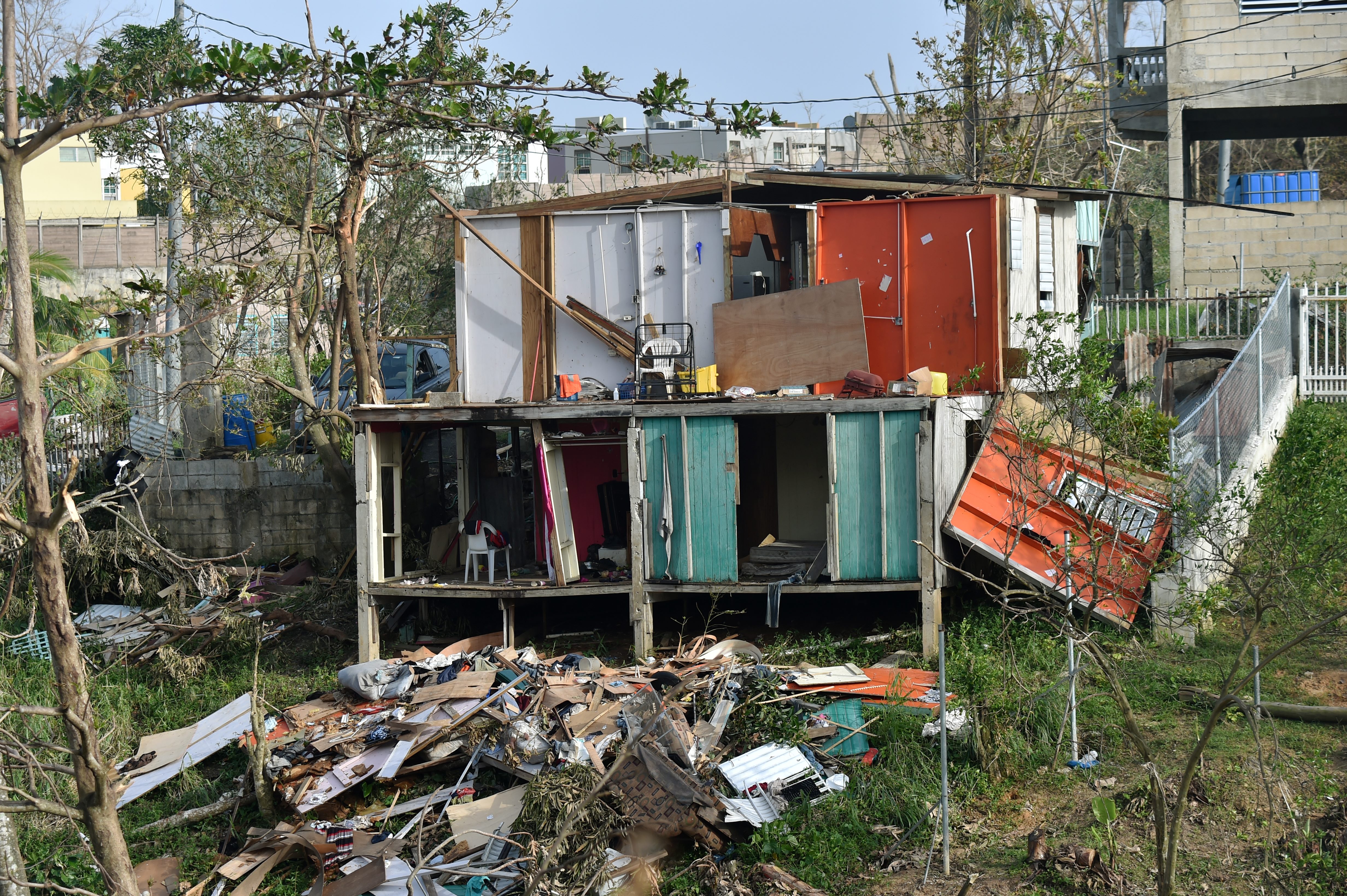 Destroyed homes are seen following passage of Hurricane Maria in the neigborhood of Acerolas in Toa Alto, Puerto Rico, on September 26, 2017. The US island territory, working without electricity, is struggling to dig out and clean up from its disastrous brush with the hurricane, blamed for at least 33 deaths across the Caribbean. / AFP PHOTO / HECTOR RETAMAL (Photo credit should read HECTOR RETAMAL/AFP/Getty Images)
