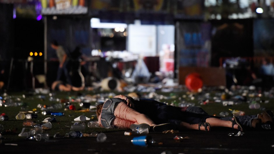 LAS VEGAS, NV - OCTOBER 01: (EDITORS NOTE: Image contains graphic content.) A person lies on the ground covered with blood at the Route 91 Harvest country music festival after apparent gun fire was heard on October 1, 2017 in Las Vegas, Nevada. There are reports of an active shooter around the Mandalay Bay Resort and Casino. (Photo by David Becker/Getty Images)