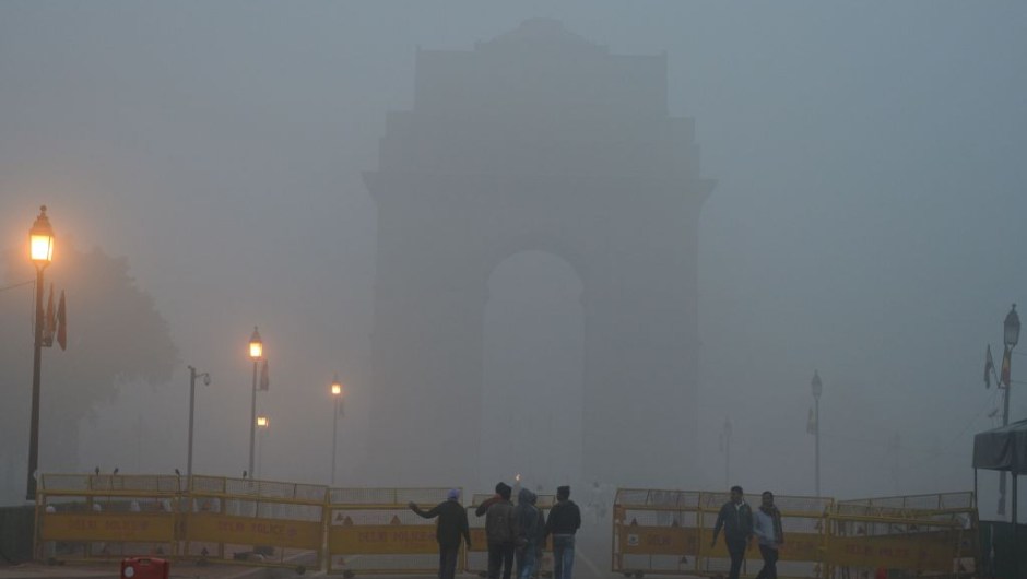 Indian pedestrians walk near the India Gate monument amid heavy smog in New Delhi on November 8, 2017. Delhi shut all primary schools on November 8 as pollution levels hit nearly 30 times the World Health Organization safe level, prompting doctors in the Indian capital to warn of a public health emergency. Dense grey smog shrouded the roads of the world's most polluted capital, where many pedestrians and bikers wore masks or covered their mouths with handkerchiefs and scarves. / AFP PHOTO / SAJJAD HUSSAIN (Photo credit should read SAJJAD HUSSAIN/AFP/Getty Images)