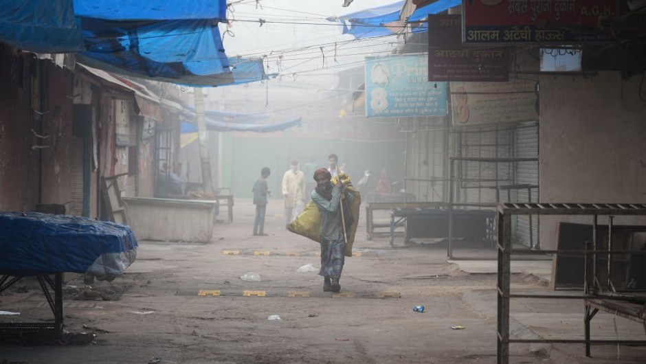 An Indian ragpicker walks amid heavy smog in New Delhi on November 8, 2017. Delhi shut all primary schools on November 8 as pollution levels hit nearly 30 times the World Health Organization safe level, prompting doctors in the Indian capital to warn of a public health emergency. Dense grey smog shrouded the roads of the world's most polluted capital, where many pedestrians and bikers wore masks or covered their mouths with handkerchiefs and scarves. / AFP PHOTO / SAJJAD HUSSAIN (Photo credit should read SAJJAD HUSSAIN/AFP/Getty Images)