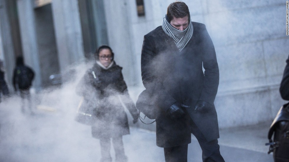 NEW YORK, NY - JANUARY 07: A man clenches his fists while walking past a steam vent on the morning of January 7, 2014 in New York, United States. A polar vortex has descended on much of North America, coming down from the Arctic, bringing record freezing temperatures across much of the country. (Photo by Andrew Burton/Getty Images)