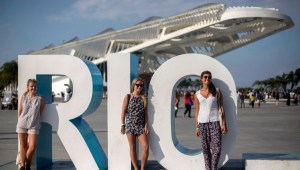 ourists pose to photos with the Museum of Tomorrow on the background in Rio de Janeiro, Brazil, on September 19, 2017. / AFP PHOTO / Mauro PIMENTEL (Photo credit should read MAURO PIMENTEL/AFP/Getty Images)