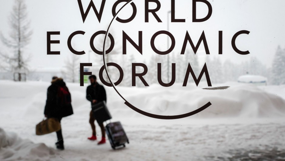 Davos Two people leave the Congress Centre under snow ahead of the opening of the World Economic Forum (WEF) 2018 annual meeting, on January 22, 2018 in Davos, eastern Switzerland. US President Donald Trump's participation at the World Economic Forum in Davos, Switzerland next week could be thrown into question now that the federal government has partially shut down over budget wrangling, the White House said on January 20. / AFP PHOTO / Fabrice COFFRINI (Photo credit should read FABRICE COFFRINI/AFP/Getty Images)