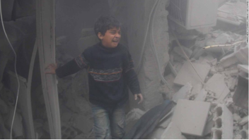 Niño entre ruinas tras un bombardeo en Guta Oriental, Siria