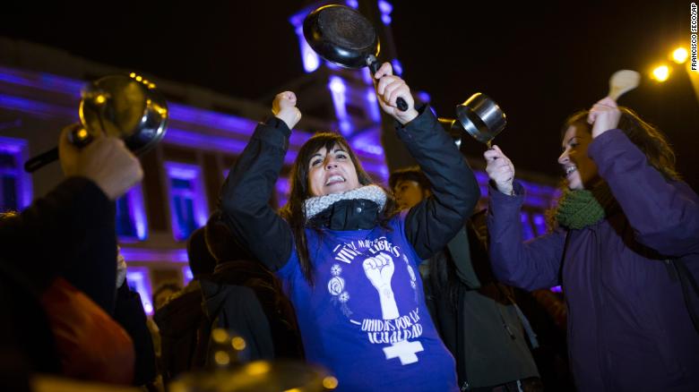 Women bang pots and pans as shooting slogans during a protest marking the beginning of a 24-hour women strike at the Sol square in Madrid, early Thursday, March 8, 2018. Women in Spain have been called for a 24-hour feminist strike in their workplaces and also stop doing duties at home during the International Women's Day. (AP Photo/Francisco Seco)