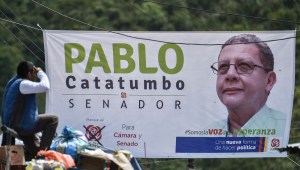 A billboard depicting Pablo Catatumbo, senate candidate for the Common Alternative Revolutionary Force (FARC) political party is seen in Monteloro, Valle del Cauca Department, Colombia, on February 25, 2018 ahead of the weekend's parliamentary election. Since the peace deal struck with the government of outgoing President Juan Manuel Santos in 2016, the Revolutionary Armed Forces of Colombia (FARC) gave up its half-century armed struggle and became a political party keeping the same acronym. / AFP PHOTO / Luis ROBAYO (Photo credit should read LUIS ROBAYO/AFP/Getty Images)