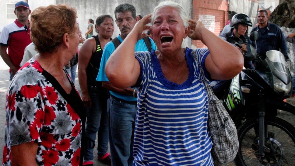 relative of a prisoner cries in front of a police station in Valencia on March 28, 2018, after a fire engulfed police holding cells that resulted in the deaths of 68 people. A total of 68 people died on March 28 during an attempted jailbreak in Venezuela after a fire engulfed police holding cells in one of the worst tragedies in years in a notoriously violent and overcrowded prison system. / AFP PHOTO / Katherine ORTIZ / The erroneous mention[s] appearing in the metadata of this photo by Katherine ORTIZ has been modified in AFP systems in the following manner: [2018] instead of [2017]. Please immediately remove the erroneous mention[s] from all your online services and delete it (them) from your servers. If you have been authorized by AFP to distribute it (them) to third parties, please ensure that the same actions are carried out by them. Failure to promptly comply with these instructions will entail liability on your part for any continued or post notification usage. Therefore we thank you very much for all your attention and prompt action. We are sorry for the inconvenience this notification may cause and remain at your disposal for any further information you may require. (Photo credit should read KATHERINE ORTIZ/AFP/Getty Images)