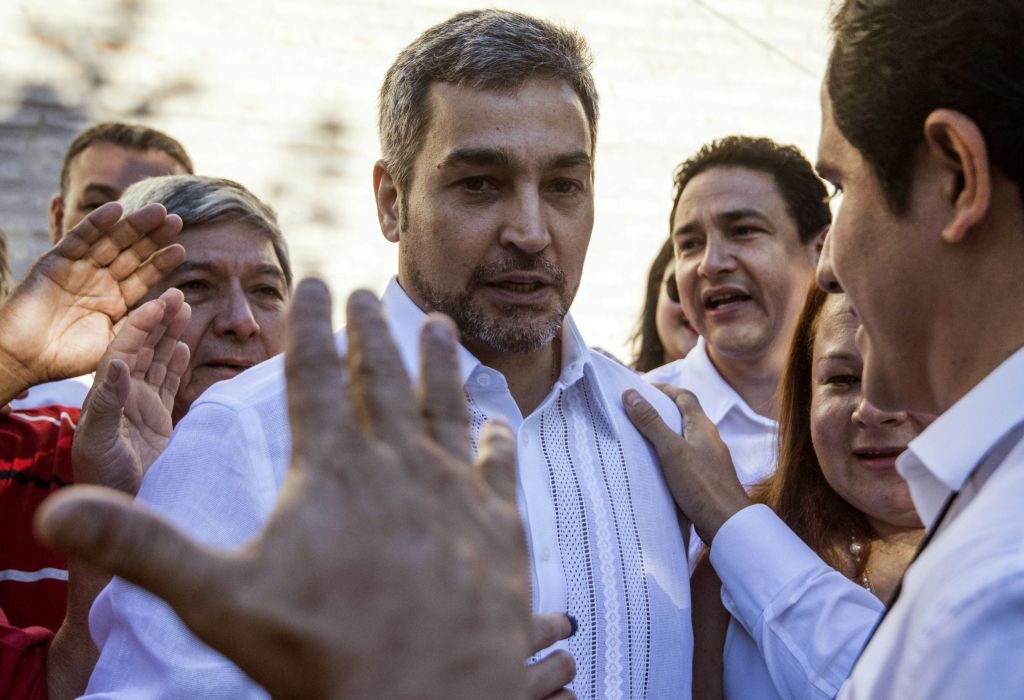 Paraguay's presidential candidate of the Colorado Party, Mario Abdo Benitez (C) greets supporters after casting his vote at a polling station in Asuncion on April 22, 2018 during the country's presidential election. - Opinion polls give Mario Abdo Benitez of the ruling conservative Colorado party a clear lead over his centrist opponent, Efrain Alegre, in a two-horse race to succeed outgoing conservative President Horacio Cartes. (Photo by EITAN ABRAMOVICH / AFP) (Photo credit should read EITAN ABRAMOVICH/AFP/Getty Images)
