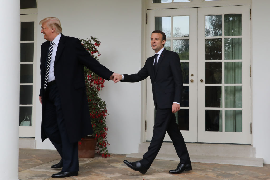 French President Emmanuel Macron (R) and US President Donald Trump (R) walk hand in hand under the colonnades of the White House in Washington, DC, on April 24, 2018. (Photo by ludovic MARIN / AFP) (Photo credit should read LUDOVIC MARIN/AFP/Getty Images)