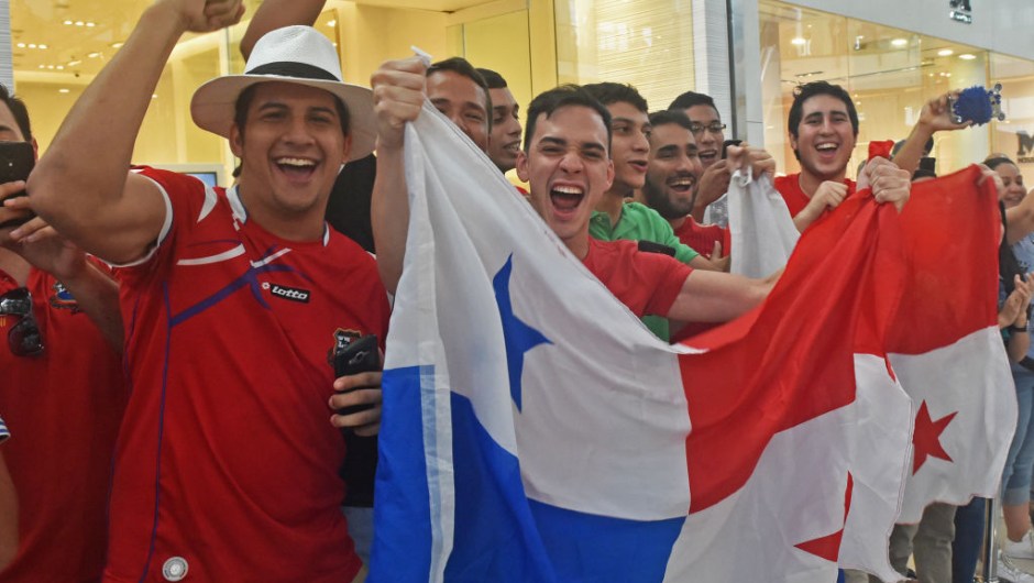 Panama's football team fans wave a national flag and cheer for their team in a mall in Panama City, a day after their national team qualified for the World Cup, for the first time ever, on October 11, 2017. Panama president Juan Carlos Varela declared a national holiday in celebration at the central American country's first ever qualification for the World Cup. / AFP PHOTO / RODRIGO ARANGUA (Photo credit should read RODRIGO ARANGUA/AFP/Getty Images)