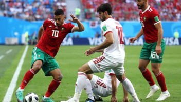 SAINT PETERSBURG, RUSSIA - JUNE 15: Younes Belhanda of Morocco is challenged by Karim Ansarifard of Iran during the 2018 FIFA World Cup Russia group B match between Morocco and Iran at Saint Petersburg Stadium on June 15, 2018 in Saint Petersburg, Russia. (Photo by
