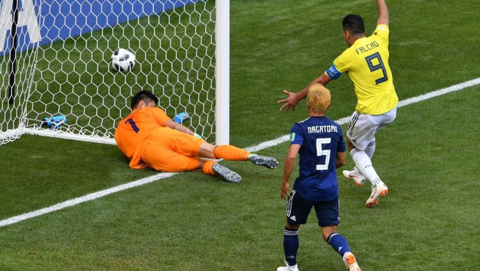 Japan's goalkeeper Eiji Kawashima (L) blocks the ball in his goal after Colombia's midfielder Juan Quintero (unseen) scored during the Russia 2018 World Cup Group H football match between Colombia and Japan at the Mordovia Arena in Saransk on June 19, 2018. (Photo by Mladen ANTONOV / AFP) / RESTRICTED TO EDITORIAL USE - NO MOBILE PUSH ALERTS/DOWNLOADS (Photo credit should read MLADEN ANTONOV/AFP/Getty Images)