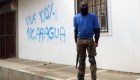 TOPSHOT - A paramilitary stands guard in a street of Monimbo neighborhood next to a grafitti reading "Long live Nicaragua 100%" in Masaya, Nicaragua, on July 18, 2018, following clashes with anti-government demonstrators. - The head of the Inter-American Commission on Human Rights has described as "alarming" the ongoing violence in Nicaragua, where months of clashes between protesters and the forces of President Daniel Ortega have claimed almost 300 lives. (Photo by MARVIN RECINOS / AFP) (Photo credit should read MARVIN RECINOS/AFP/Getty Images)