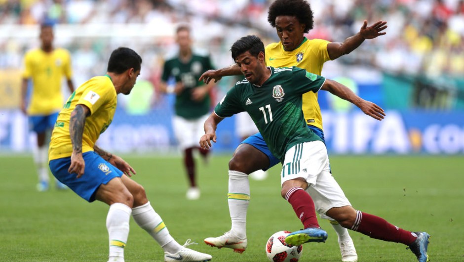 Carlos Vela of Mexico is challenged by Willian and Fagner of Brazil during the 2018 FIFA World Cup Russia Round of 16 match between Brazil and Mexico at Samara Arena on July 2, 2018 in Samara, Russia. (Photo by Buda Mendes/Getty Images)