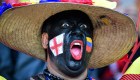 Un hombre con las banderas de Inglaterra y Colombia antes del partido que enfrentará a ambas selecciones. (Crédito: ALEXANDER NEMENOV/AFP/Getty Images)