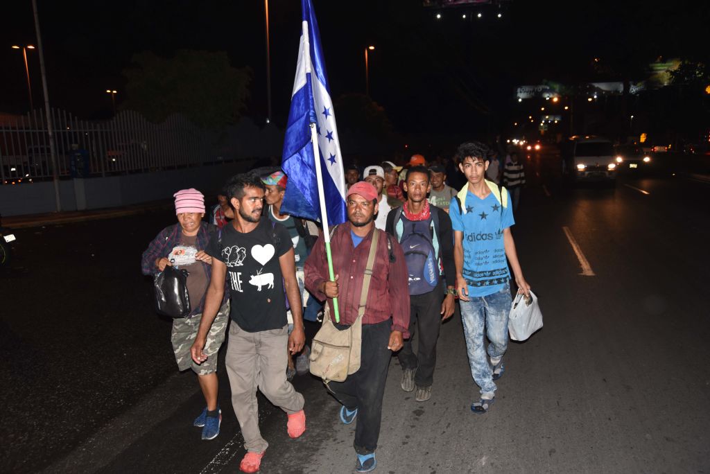 TOPSHOT - Honduran migrants taking part in a caravan to the United States arrive in Guatemala City, Guatemala, on October 17, 2018. - Thousands of Honduran migrants marched north on October 17 in a bold attempt to reach the United States, defying threats from US President Donald Trump to stop aid to countries that let them pass. (Photo by Orlando ESTRADA / AFP) (Photo credit should read ORLANDO ESTRADA/AFP/Getty Images)