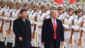 China's President Xi Jinping (L) and US President Donald Trump review Chinese honour guards during a welcome ceremony at the Great Hall of the People in Beijing on November 9, 2017. / AFP PHOTO / JIM WATSON (Photo credit should read JIM WATSON/AFP/Getty Images)