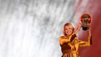 TOPSHOT - Olympique Lyonnais' Norwegian forward Ada Hegerberg brandishes her trophy after receiving the 2018 FIFA Women's Ballon d'Or award for best player of the year during the 2018 FIFA Ballon d'Or award ceremony at the Grand Palais in Paris on December 3, 2018. - The winner of the 2018 Ballon d'Or will be revealed at a glittering ceremony in Paris on December 3 evening, with Croatia's Luka Modric and a host of French World Cup winners all hoping to finally end the 10-year duopoly of Cristiano Ronaldo and Lionel Messi. (Photo by FRANCK FIFE / AFP) (Photo credit should read FRANCK FIFE/AFP/Getty Images)