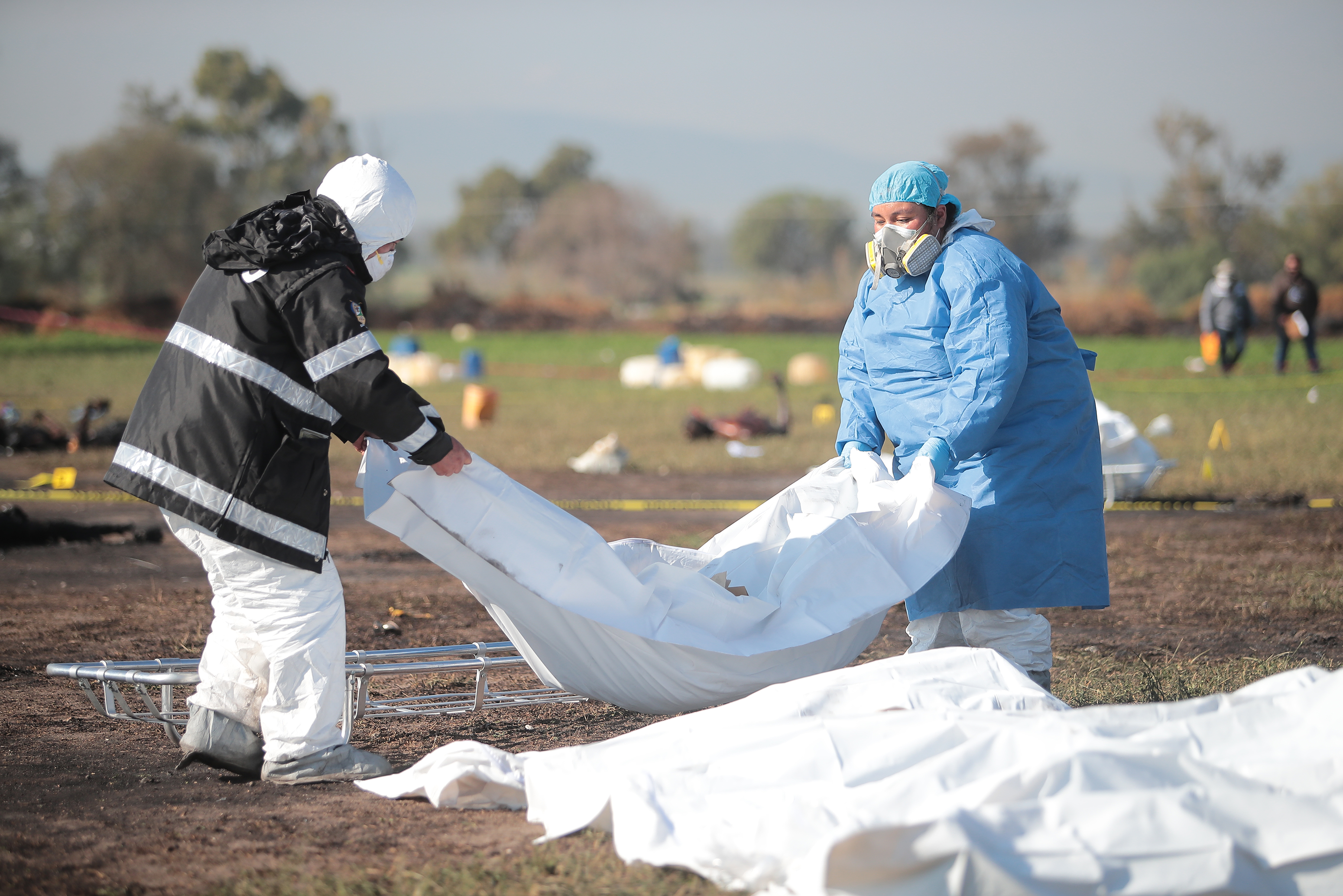 TLAHUELILPAN, MEXICO - JANUARY 19: (EDITOR'S NOTE: Image depicts graphic content) Forensic doctors work with burned bodies after an explosion in a pipeline belonging to Mexican oil company PEMEX on January 19, 2019 in Tlahuelilpan, Mexico. In a statement, PEMEX announced that the explosion was caused by the illegal manipulation of the pipeline, as minutes before the accident videos were shot where people could be seen filling drums and car fuel tanks. (Photo by Hector Vivas/Getty Images)