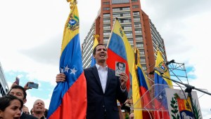 Venezuela's National Assembly head Juan Guaido declares himself the country's "acting president" during a mass opposition rally against leader Nicolas Maduro, on the anniversary of a 1958 uprising that overthrew a military dictatorship, in Caracas on January 23, 2019. - Moments earlier, the loyalist-dominated Supreme Court ordered a criminal investigation of the opposition-controlled legislature. "I swear to formally assume the national executive powers as acting president of Venezuela to end the usurpation, (install) a transitional government and hold free elections," said Guaido as thousands of supporters cheered. (Photo by Federico PARRA / AFP) (Photo credit should read FEDERICO PARRA/AFP/Getty Images)