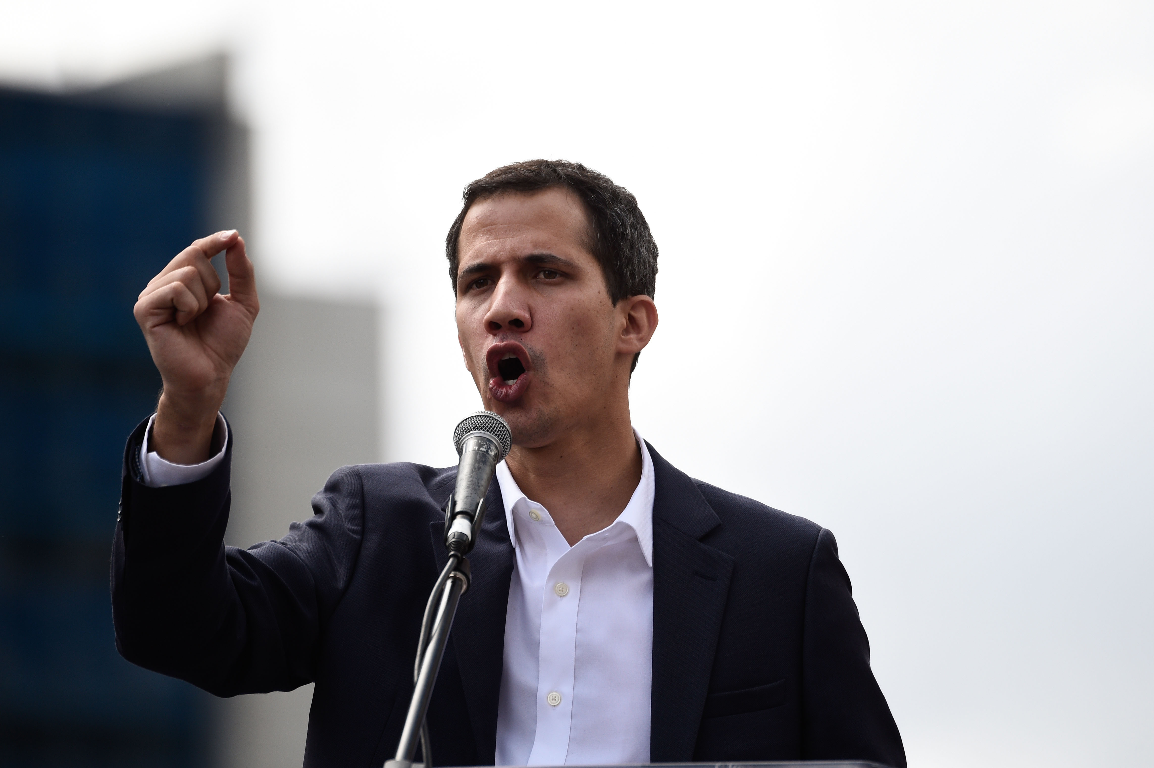 Venezuela's National Assembly head Juan Guaido speaks to the crowd during a mass opposition rally against leader Nicolas Maduro in which he declared himself the country's "acting president", on the anniversary of a 1958 uprising that overthrew military dictatorship, in Caracas on January 23, 2019. - "I swear to formally assume the national executive powers as acting president of Venezuela to end the usurpation, (install) a transitional government and hold free elections," said Guaido as thousands of supporters cheered. Moments earlier, the loyalist-dominated Supreme Court ordered a criminal investigation of the opposition-controlled legislature. (Photo by Federico PARRA / AFP) (Photo credit should read FEDERICO PARRA/AFP/Getty Images)