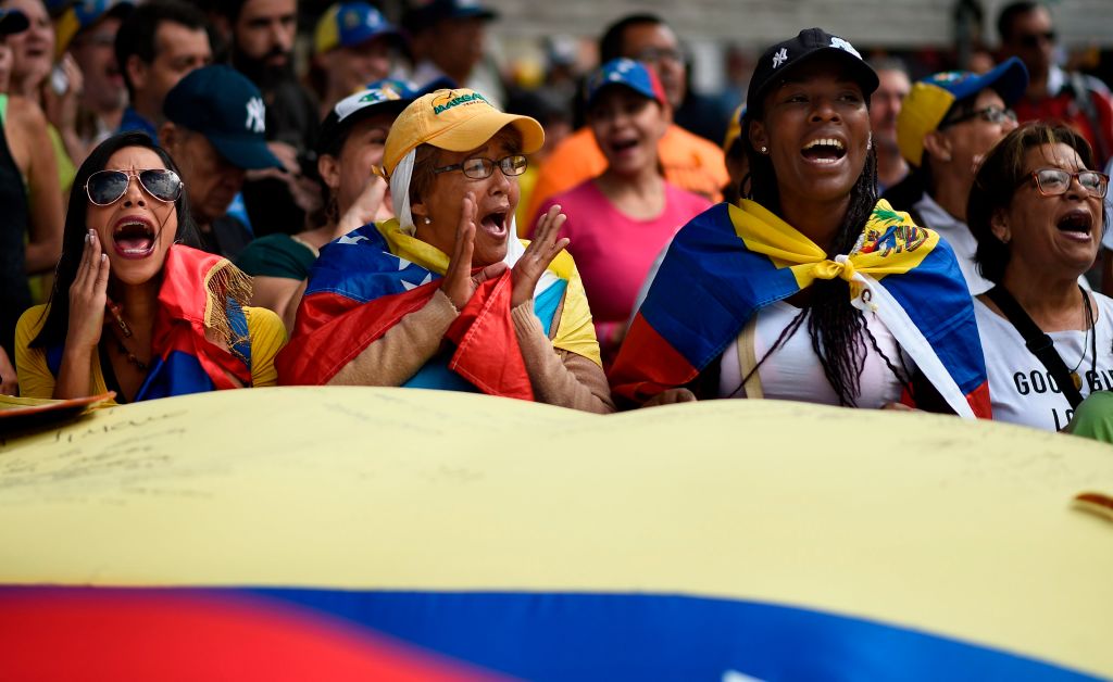 TOPSHOT - Supporters of Venezuelan opposition leader and self declared acting president Juan Guaido, cheer as they start gathering for a rally to press the military to let in US humanitarian aid, in eastern Caracas on February 12, 2019. - The tug of war between the government and opposition is centred on whether humanitarian aid will be allowed into the economically crippled country, which suffers shortages of food, medicine and other basics. (Photo by Federico PARRA / AFP) (Photo credit should read FEDERICO PARRA/AFP/Getty Images)