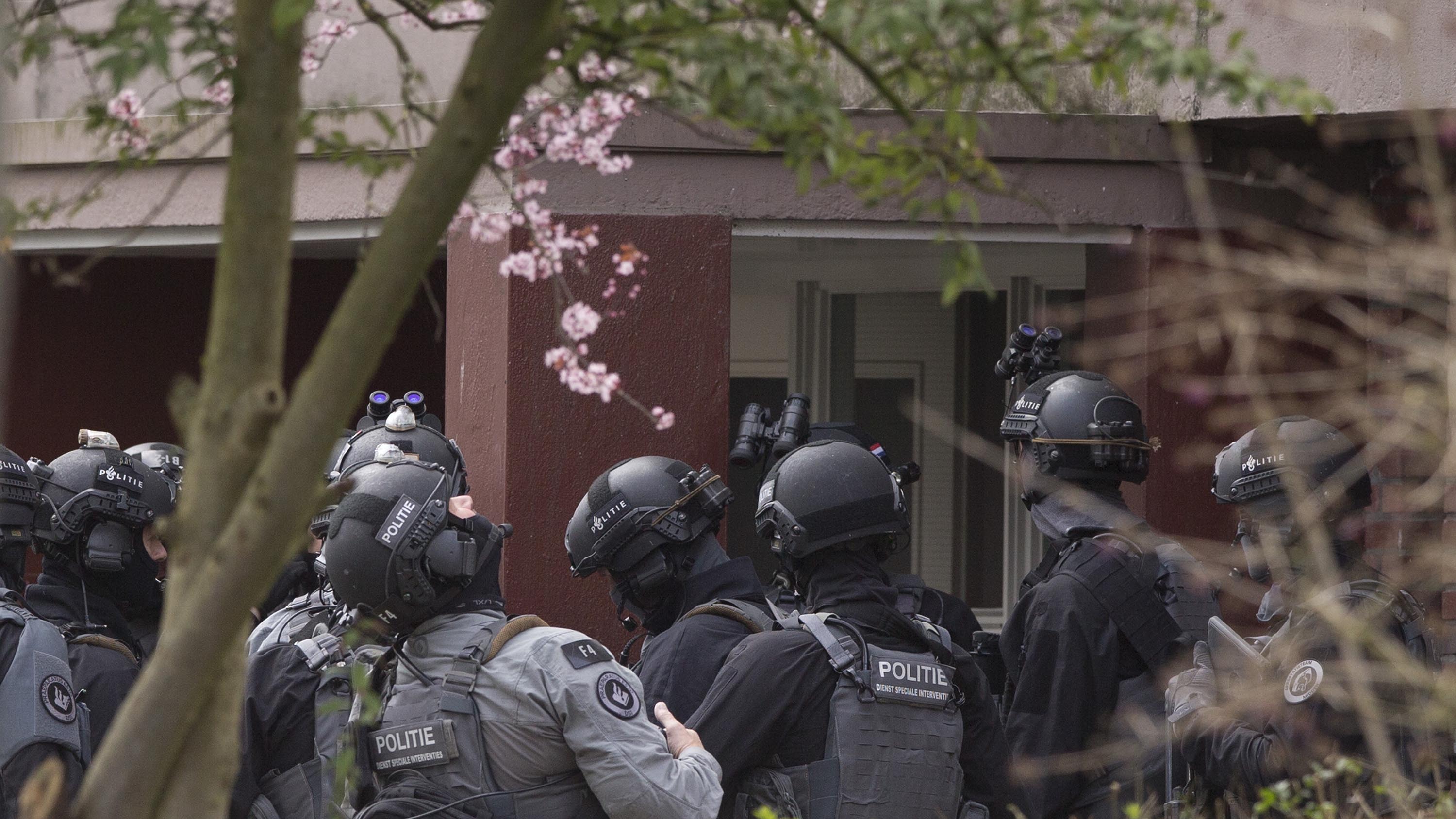 Dutch counter terrorism police prepare to enter a house after a shooting incident in Utrecht, Netherlands, Monday, March 18, 2019. Police in the central Dutch city of Utrecht say on Twitter that "multiple" people have been injured as a result of a shooting in a tram in a residential neighborhood. (AP Photo/Peter Dejong)