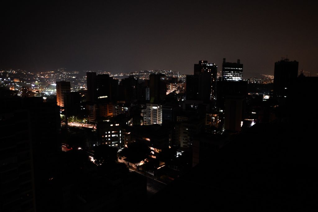 TOPSHOT - General view of Altamira neighborhood partially illuminated during a power outage in Caracas, Venezuela, on March 26, 2019. - Venezuela decreed a 24-hour holiday Tuesday to cope with a new near-nationwide blackout that the government alleged was caused by an "attack" targeting its main hydroelectric plant. (Photo by FEDERICO PARRA / AFP) (Photo credit should read FEDERICO PARRA/AFP/Getty Images)