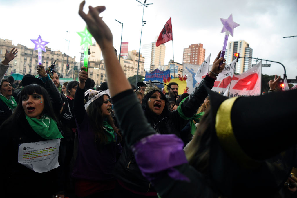 TOPSHOT - Women chant slogans as they take part in a march called by the movement "Ni una menos" (Not One Less) against violence against women, and in demand of the right to a safe, free and legal abortion in Buenos Aires, on June 04, 2018. (Photo by EITAN ABRAMOVICH / AFP) (Photo credit should read EITAN ABRAMOVICH/AFP/Getty Images)