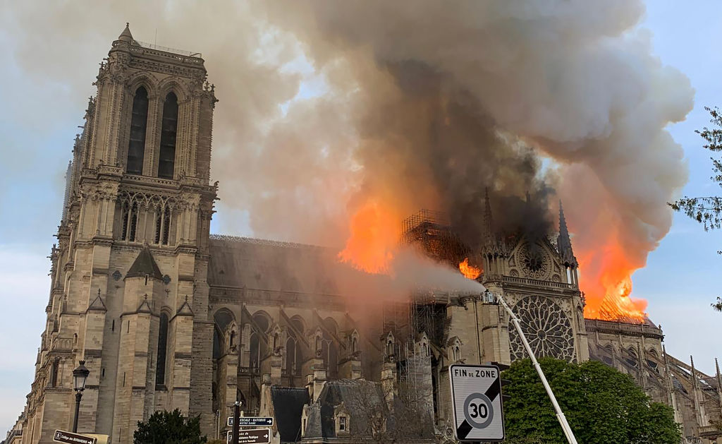 Flames and smoke are seen billowing from the roof at Notre-Dame Cathedral in Paris on April 15, 2019. - A fire broke out at the landmark Notre-Dame Cathedral in central Paris, potentially involving renovation works being carried out at the site, the fire service said.Images posted on social media showed flames and huge clouds of smoke billowing above the roof of the gothic cathedral, the most visited historic monument in Europe. (Photo by Patrick ANIDJAR / AFP) (Photo credit should read PATRICK ANIDJAR/AFP/Getty Images) FRANCE-FIRE-NOTRE DAME