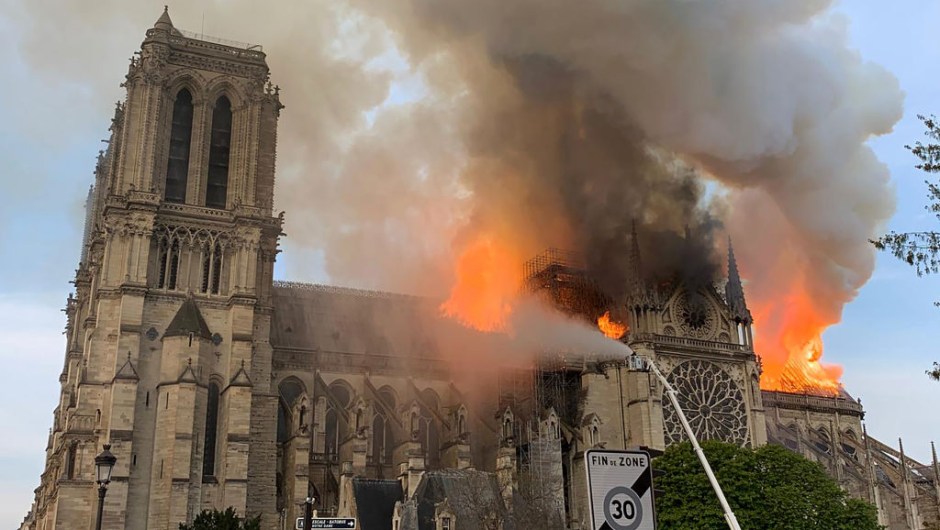 Flames and smoke are seen billowing from the roof at Notre-Dame Cathedral in Paris on April 15, 2019. - A fire broke out at the landmark Notre-Dame Cathedral in central Paris, potentially involving renovation works being carried out at the site, the fire service said.Images posted on social media showed flames and huge clouds of smoke billowing above the roof of the gothic cathedral, the most visited historic monument in Europe. (Photo by Patrick ANIDJAR / AFP) (Photo credit should read PATRICK ANIDJAR/AFP/Getty Images) FRANCE-FIRE-NOTRE DAME