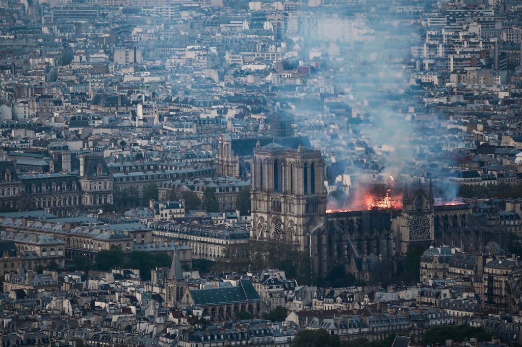 Smoke and flames rise during a fire at the landmark Notre-Dame Cathedral in central Paris on April 15, 2019, potentially involving renovation works being carried out at the site, the fire service said. - A major fire broke out at the landmark Notre-Dame Cathedral in central Paris sending flames and huge clouds of grey smoke billowing into the sky, the fire service said. The flames and smoke plumed from the spire and roof of the gothic cathedral, visited by millions of people a year, where renovations are currently underway. (Photo by Philippe LOPEZ / AFP) (Photo credit should read PHILIPPE LOPEZ/AFP/Getty Images)