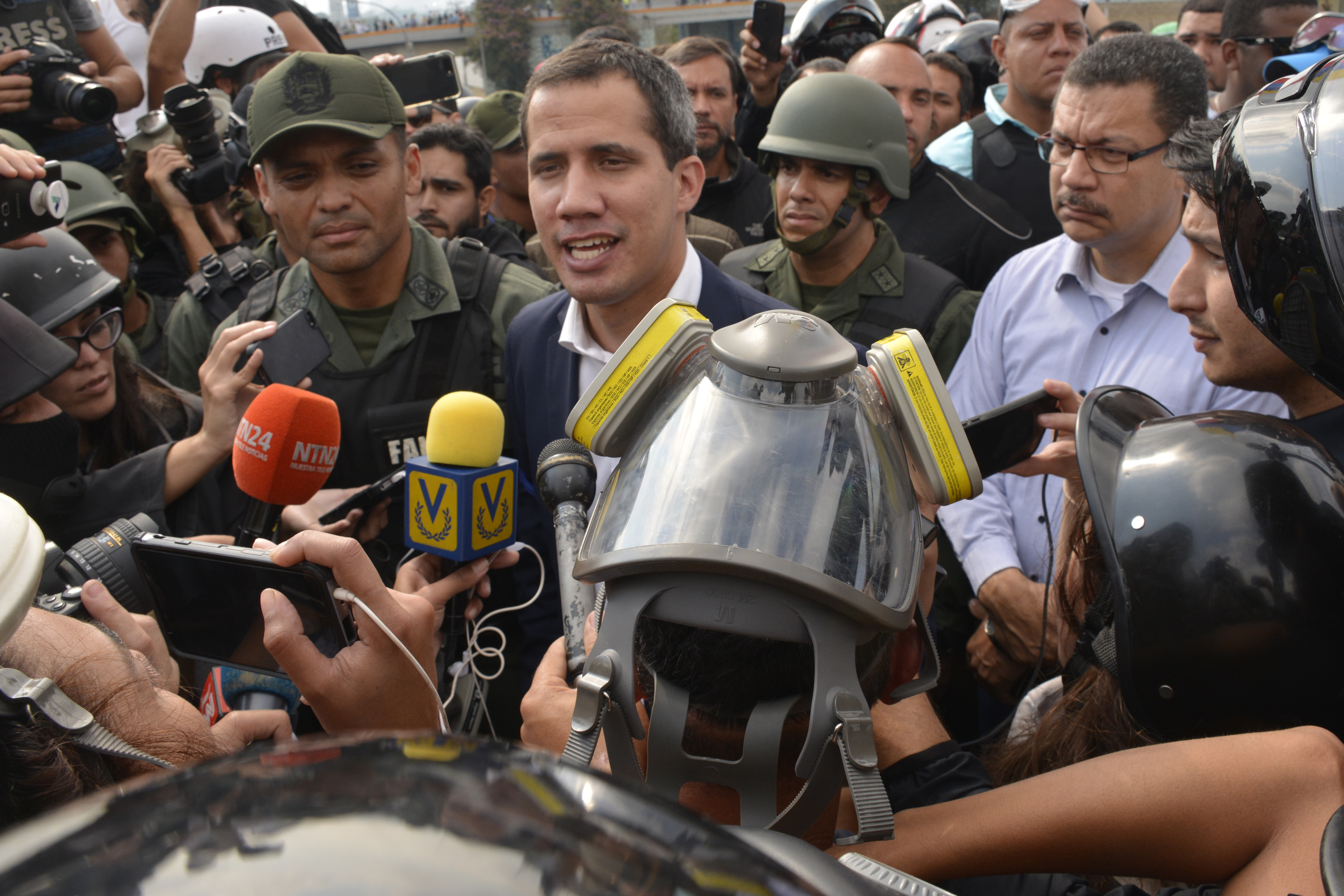 CARACAS, VENEZUELA - APRIL 30: Venezuelan opposition leader Juan Guaidó, recognized by many members of the international community as the country's rightful interim ruler, talks to media out of airforce base La Carlota on April 30, 2019 in Caracas, Venezuela. Through a live broadcast via social media, Venezuelan opposition leader Juan Guaido called for a military uprising against the government of Nicolás Maduro. He declared to be at the air base of La Carlota and was seen surrounded by soldiers and opposition activist Leopoldo Lopez, who was under house arrest. (Photo by Rafael Briceno/Getty Images)