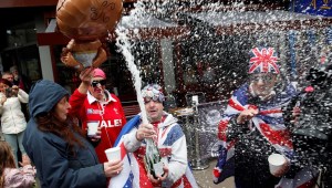 Royal super fans John Loughery (C) pops the cork on a bottle of champagne, as they stand near Windsor Castle in Windsor, west of London on May 6, 2019, following the announcement that Britain's Meghan, Duchess of Sussex has given birth to a son. - Meghan Markle, the Duchess of Sussex, gave birth on Monday to a "very healthy" boy, Prince Harry announced. "We're delighted to announce that Meghan and myself had a baby boy early this morning -- a very healthy boy," a beaming Prince Harry said. (Photo by ADRIAN DENNIS / AFP) (Photo credit should read ADRIAN DENNIS/AFP/Getty Images)