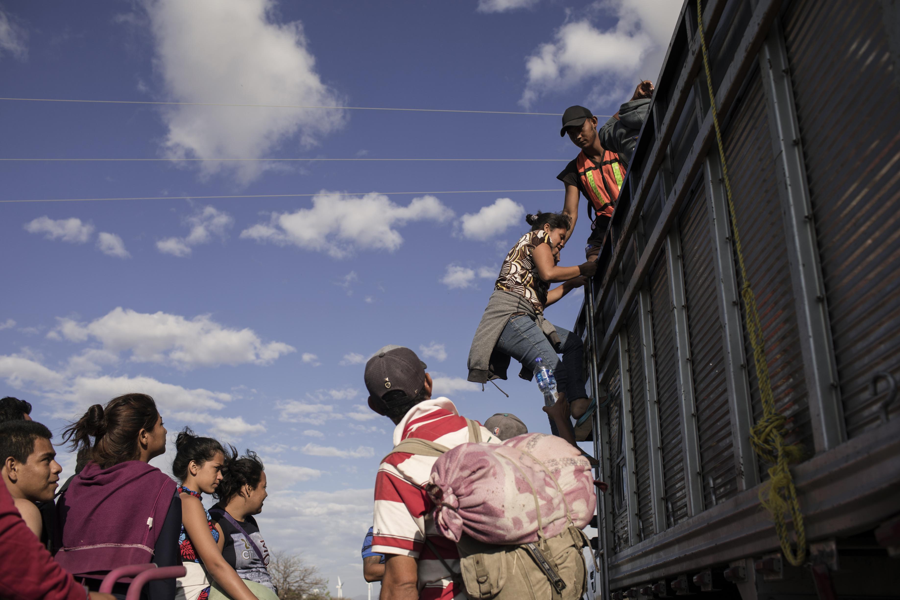 A group of Central American refugees and asylum seekers, led by the non-profit humanitarian organization Pueblos Sin Fronteras (People Without Borders), board a truck offering a ride to their next destination in the town of Santiago Niltepec, Oaxaca state, Mexico, on Saturday, March 31, 2018. The Trump administration is crafting legislation to make it harder for refugees to gain asylum in the U.S. and loosen restrictions on detaining immigrants apprehended near the border, a senior White House official said. Photographer: Jordi Ruiz Cirera/Bloomberg