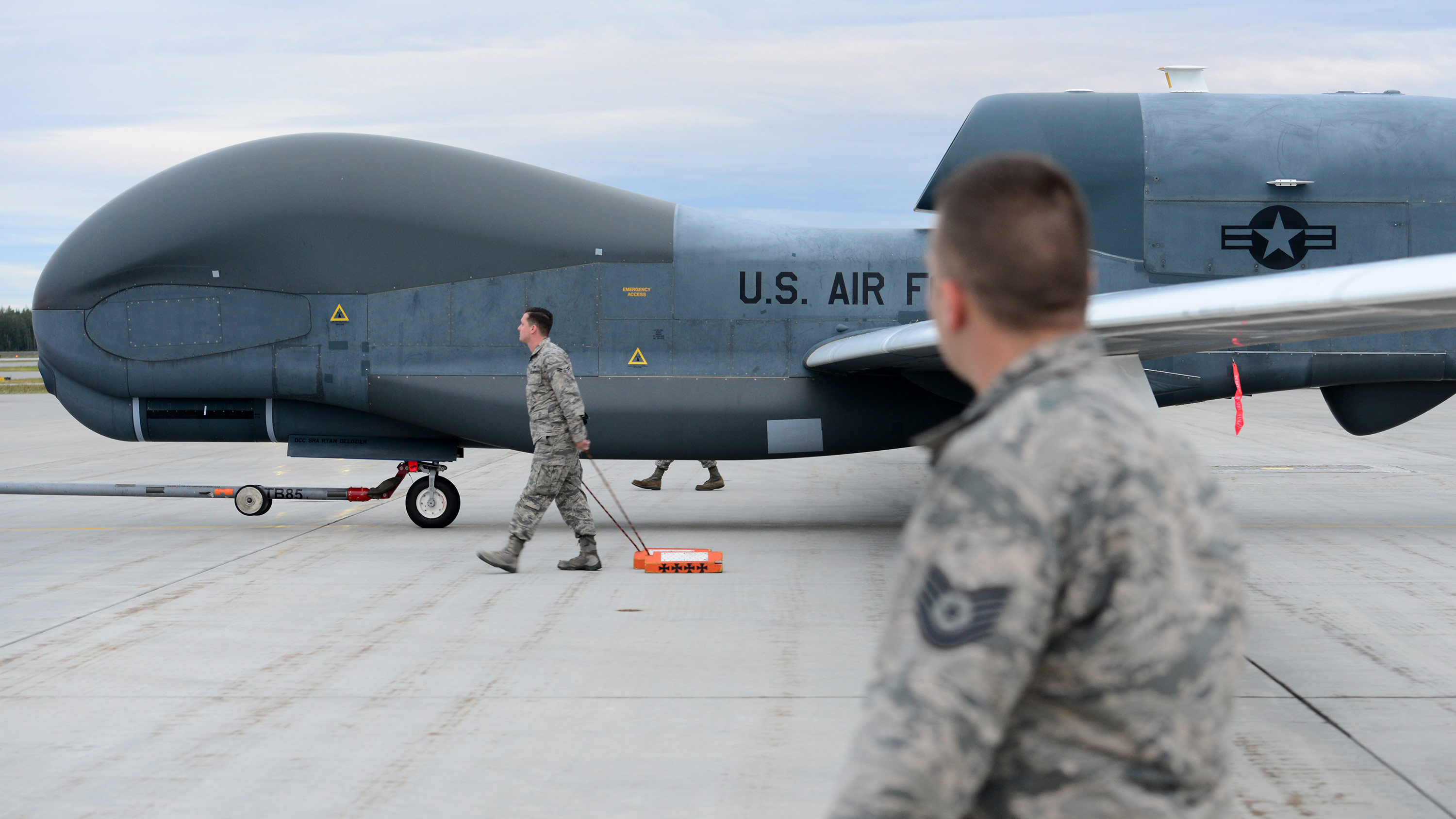 A team of 12th Aircraft Maintenance Unit Airmen walk beside an RQ-4 Global Hawk while it’s being towed during Red Flag Alaska 18-3, Aug. 16, 2018, at Eielson Air Force Base, Alaska. This marks the first time an RQ-4 has landed in Alaska during a simulated combat training exercise. (U.S. Air Force photo by Airman 1st Class Tristan D. Viglianco)