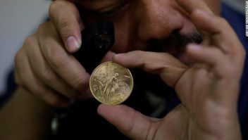 The owner of an antiques shop checks a Mexican gold coin, or Centenario, in Ciudad Juarez, Mexico November 10, 2017. Picture taken November 10, 2017. REUTERS/Jose Luis Gonzalez