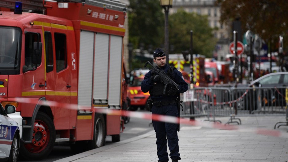 A policeman stands next to firefighter vehicles near Paris prefecture de police (police headquarters) on October 3, 2019 after four officers were killed in a knife attack. - A knife attacker was shot dead after killing four officers at police headquarters in the historical centre of Paris on October 3, sources told AFP. (Photo by Martin BUREAU / AFP) (Photo by MARTIN BUREAU/AFP via Getty Images)