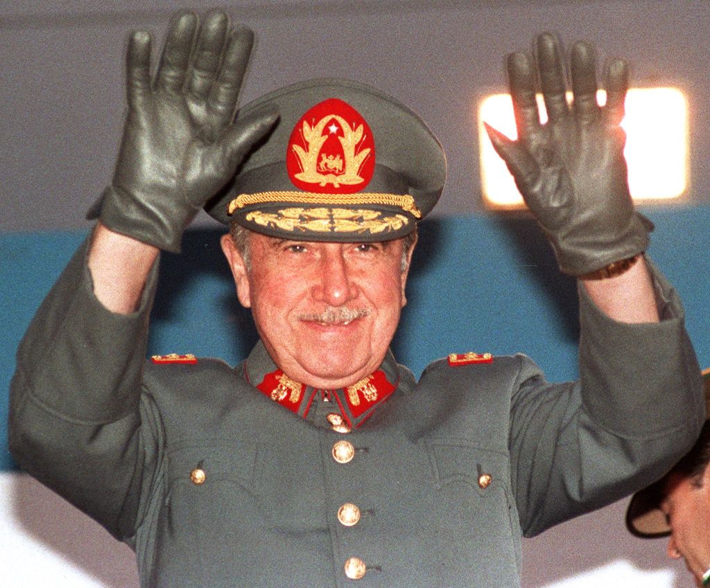 General Augusto Pinochet, then Chilean president, waves to the crowd on October 21, 1986 during a four-day-journey in Antofagasta, northern Chile. / AFP PHOTO / MARCO UGARTE (Photo credit should read MARCO UGARTE/AFP via Getty Images)