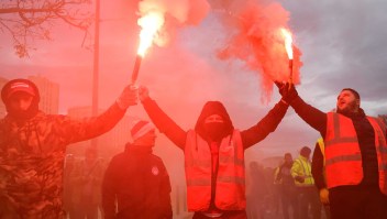 Dockers march with smoke bombs as they take part in a demonstration to protest against the pension overhauls, in Marseille, southern France, on December 5, 2019 as part of a national general strike. - Trains cancelled, schools closed: France scrambled to make contingency plans on for a huge strike against pension overhauls that poses one of the biggest challenges yet to French President's sweeping reform drive. (Photo by CLEMENT MAHOUDEAU / AFP) (Photo by CLEMENT MAHOUDEAU/AFP via Getty Images)