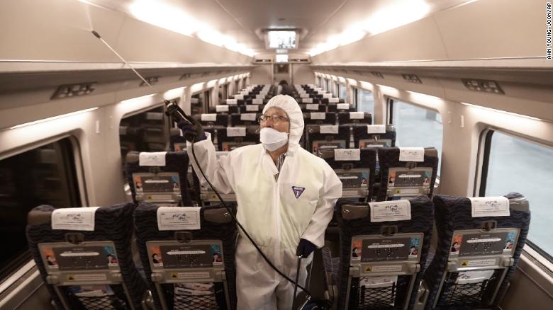 An employee sprays disinfectant on a train as a precaution against a new coronavirus at Suseo Station in Seoul, South Korea, Friday, Jan. 24, 2020. China broadened its unprecedented, open-ended lockdowns to encompass around 25 million people Friday to try to contain a deadly new virus that has sickened hundreds, though the measures' potential for success is uncertain. (AP Photo/Ahn Young-joon)