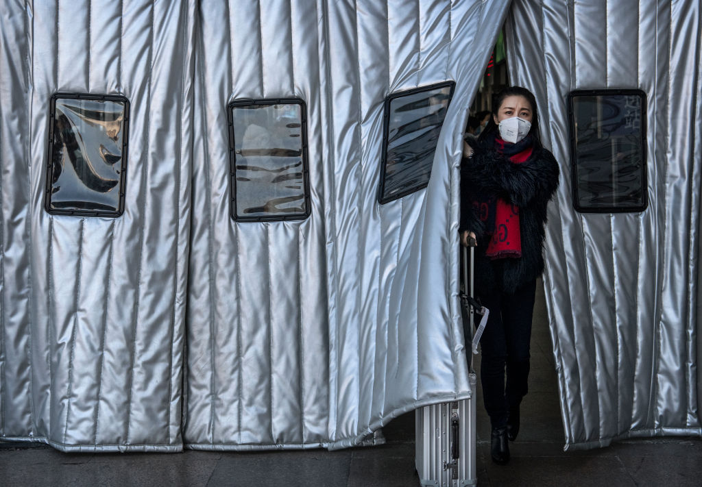 BEIJING, CHINA - JANUARY 23: A Chinese woman wears a protective mask as she leaves a Beijing railway station on January 23, 2020 in Beijing, China. The number of cases of a deadly new coronavirus rose to over 500 in mainland China Wednesday as health officials locked down the city of Wuhan in an effort to contain the spread of the pneumonia-like disease. Medicals experts have confirmed that the virus can be passed from human to human. In an unprecedented move, Chinese authorities put travel restrictions on the city of 11 million and two other neighboring cities, preventing people from leaving after 10 AM local time Thursday. The number of those who have died from the virus in China climbed to at least 17 on Thursday and cases have been reported in other countries including the United States,Thailand, Japan, Taiwan and South Korea. (Photo by Kevin Frayer/Getty Images)