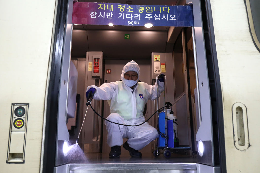 SEOUL, SOUTH KOREA - JANUARY 24: A disinfection worker wearing protective gears spray anti-septic solution in an train amid rising public concerns over the spread of China's Wuhan Coronavirus at SRT train station on January 24, 2020 in Seoul, South Korea. The number of cases of a deadly new coronavirus rose to over 800 in mainland China as health officials stepped up efforts to contain the spread of the pneumonia-like disease which medicals experts confirmed can be passed from human to human. The number of those who have died from the virus in China climbed to twentyfive on Wednesday and cases have been reported in other countries including the United States,Thailand, Japan, Taiwan and South Korea. (Photo by Chung Sung-Jun/Getty Images)