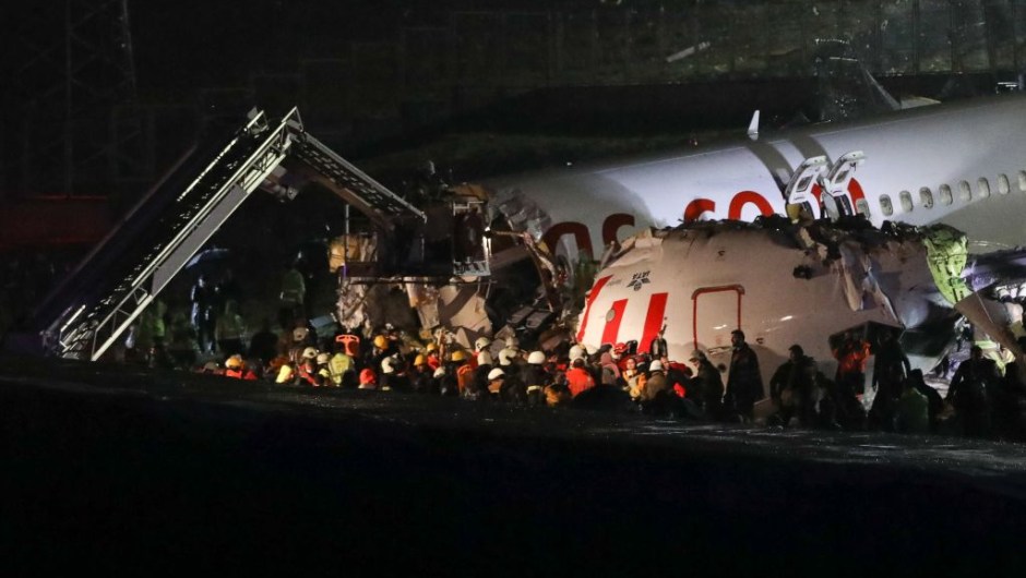 Rescuers work to extract passengers from the crash of a Pegasus Airlines Boeing 737 airplane, after it skidded off the runway upon landing at Sabiha Gokcen airport in Istanbul on February 5, 2020. - The plane carrying 171 passengers from the Aegean port city of Izmir split into three after landing in rough weather. Officials said no-one had lost their lives in the accident, but dozens of people were injured. (Photo by STR / AFP) (Photo by STR/AFP via Getty Images)