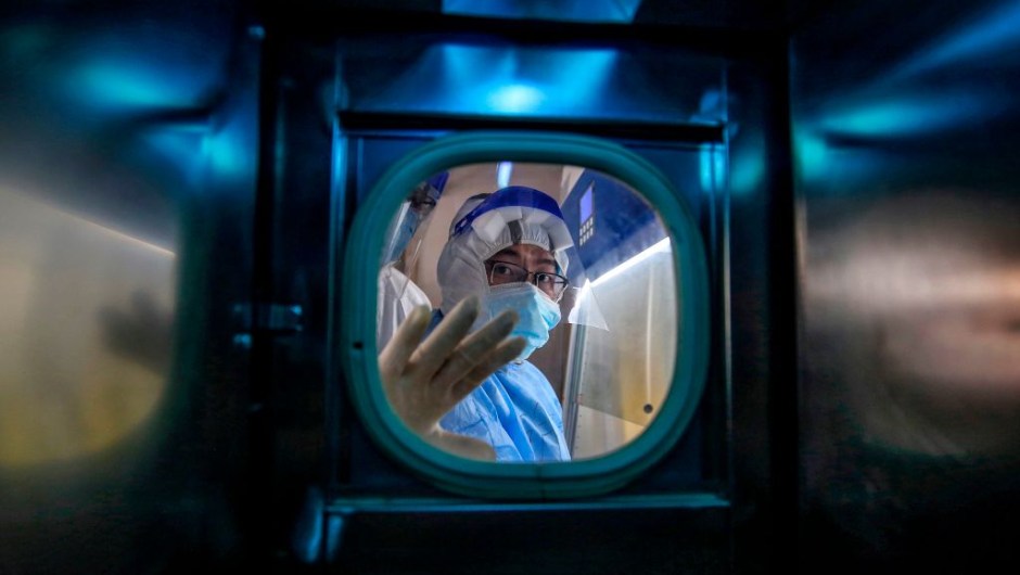 TOPSHOT - A medical staff member gestures inside an isolation ward at Red Cross Hospital in Wuhan in China's central Hubei province on March 10, 2020. - Chinese President Xi Jinping said on March 10 that Wuhan has turned the tide against the deadly coronavirus outbreak, as he paid his first visit to the city at the heart of the global epidemic. (Photo by STR / AFP) / China OUT (Photo by STR/AFP via Getty Images)