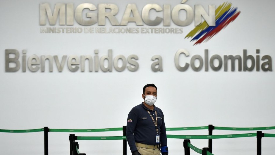 A Colombian Migration staffer waiting for passengers wears a protective face mask as a preventive measure against the spread of the new Coronavirus, COVID-19, at the Bonilla Aragon international airport in Palmira, Colombia, on March 10, 2020. (Photo by Luis ROBAYO / AFP) (Photo by LUIS ROBAYO/AFP via Getty Images)