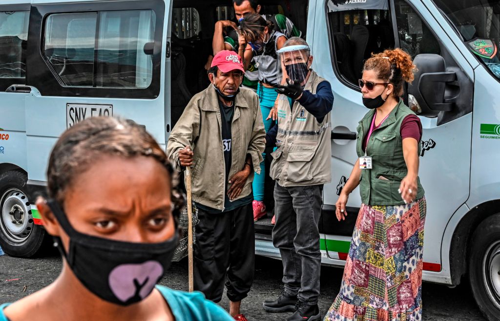 Homeless people get off a van transporting them to an area provided for them to take a shower and eat amid the COVID-19 pandemic in Medellin, Colombia, on June 23, 2020. (Photo by JOAQUIN SARMIENTO / AFP) (Photo by JOAQUIN SARMIENTO/AFP via Getty Images)