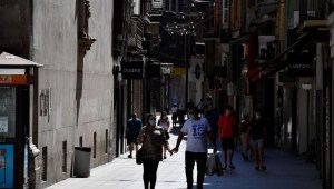 People walk down a shopping street in Lleida on July 4, 2020. - Spain's northeastern Catalonia region locked down an area with around 200,000 residents around the town of Lerida following a surge in cases of the new coronavirus. (Photo by Pau BARRENA / AFP) (Photo by PAU BARRENA/AFP via Getty Images)
