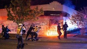 PORTLAND, OR - AUGUST 29: Portland police disperse a crowd after protesters set fire to the Portland Police Association (PPA) building early in the morning on August 29, 2020 in Portland, Oregon. The PPA, a headquarters for the Portland police union, has been a regular target during the 93 days of protests in Portland. (Photo by Nathan Howard/Getty Images)